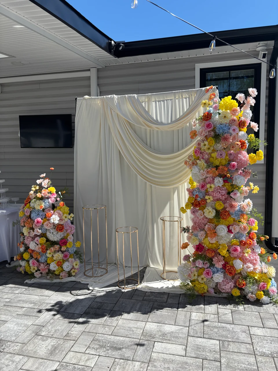 Floral arch and wall pairing at a celebration