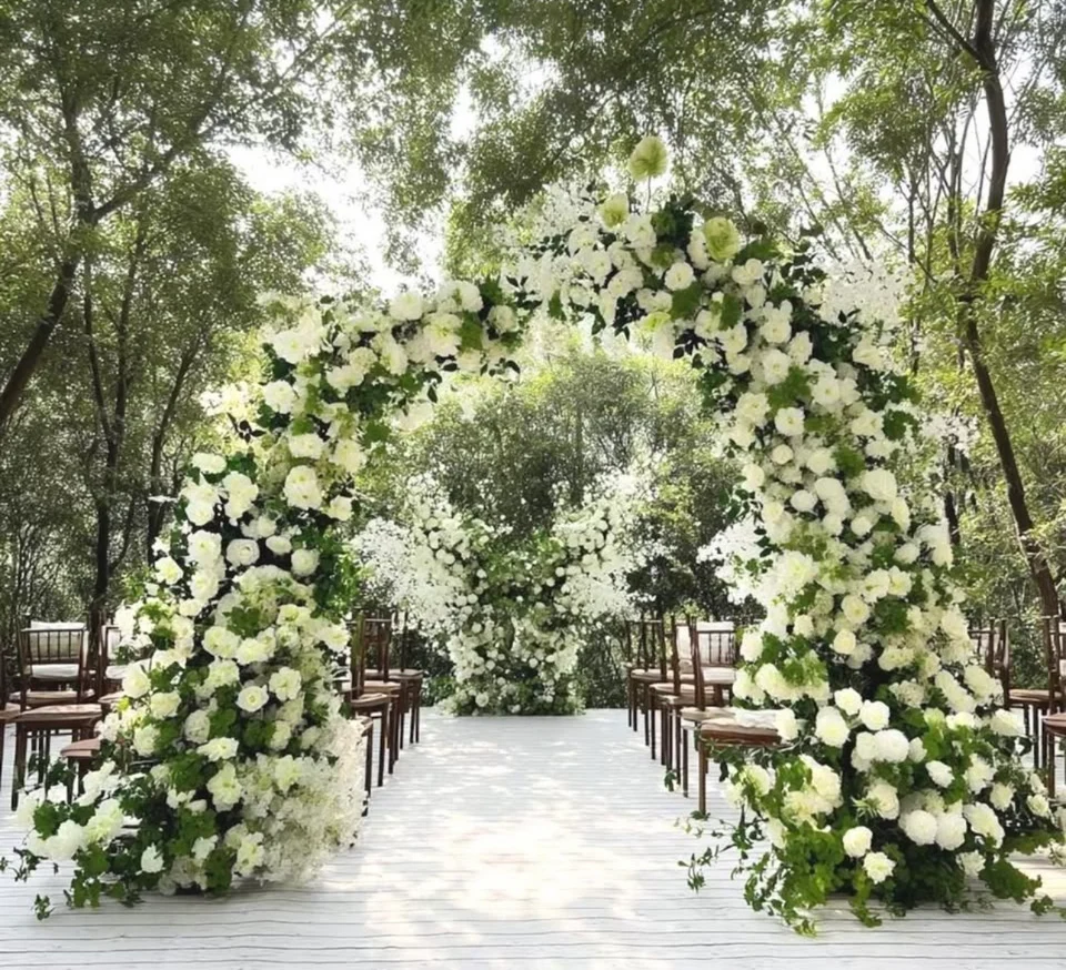 Green and white floral arch framing a ceremony